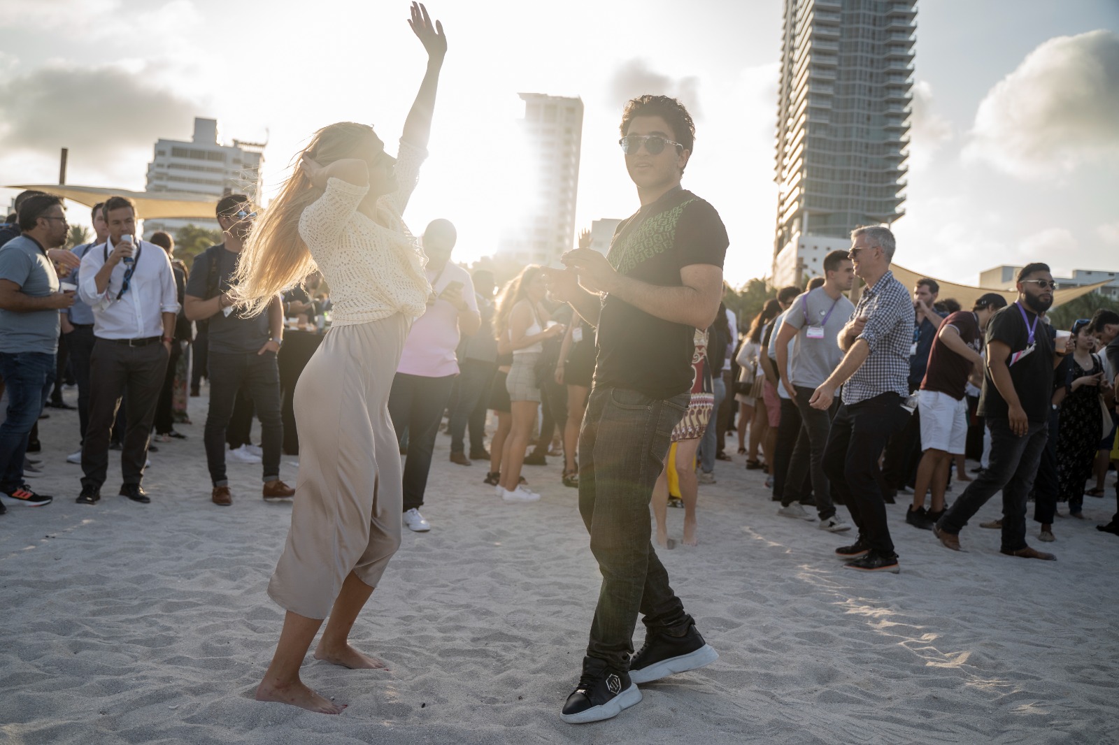 Image of a group of people dancing on the beach